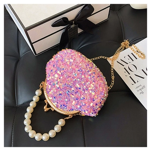 Detail showing pink sequin evening bag with large pearl handle and gold chain strap