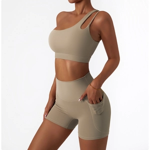 Detail showing high-waist yoga shorts with side pocket and cut-out sports bra in olive green
