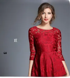 Close-up of semi-transparent neckline and red lace pattern on elegant red maxi dress