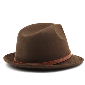 Detail of a brown suede fedora featuring a textured lychee leather decorative band