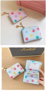 Detailed view of polka dot wallet interior with card slots and heart pendant