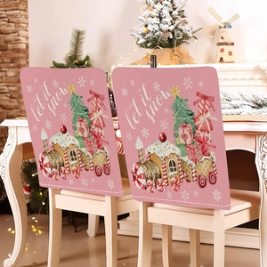 Pink Christmas chair covers with gingerbread train and tree set in cozy holiday room