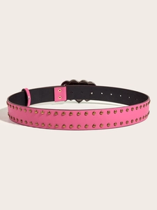 Detail of pink punk leather belt featuring heart-shaped buckle and double metal studs