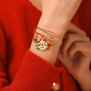 Detailed view of adjustable gold Christmas bracelet with snowman and tree charms