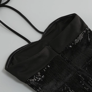 Close-up of black sequined dress showing halter straps and high-quality zipper detail