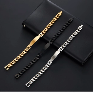 Three Cuban link ID bracelets in gold, black and silver finishes on a black leather wallet
