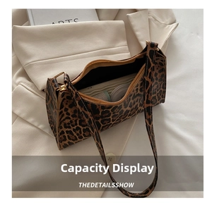 Detailed internal view showing capacity of leopard print shoulder bag on blazer