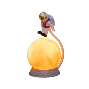 Astronaut night light with floating spaceman and glowing textured moon base lamp