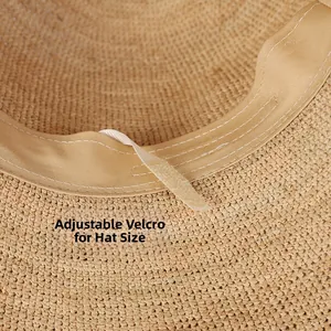 Detail view of woven raffia sun hat featuring adjustable velcro strap and sweatband