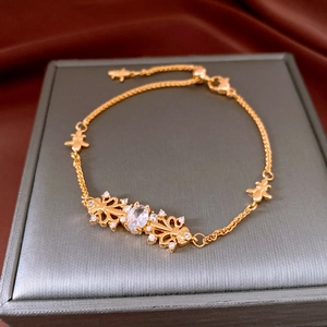Detailed view of vintage iris hollow bracelet with gold finish and sparkling zircons