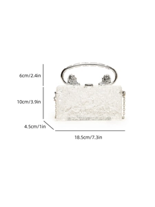 Detail view of acrylic clutch bag dimensions with lion head handle and ice crack texture