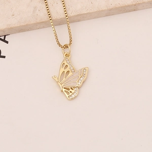 Detail of gold butterfly necklace with white shell inlay and zircon accents