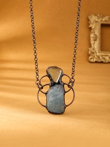Detail view of handmade vintage necklace with raw aquamarine and fluorite crystals