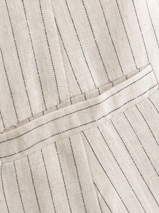 Macro shot of striped cotton linen fabric texture and stitching detail on the vest
