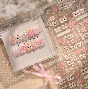 Close-up of pink lion dance nail art stickers and press-on nails with floral patterns