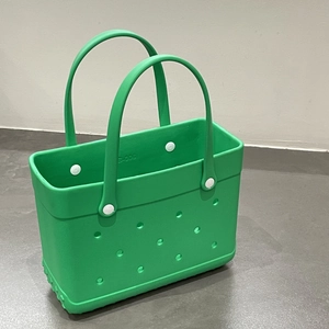 Detailed side view of a vibrant green EVA beach bag featuring a DIY hole pattern
