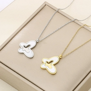 Detailed view of gold and silver stainless steel necklaces with white butterfly pendants