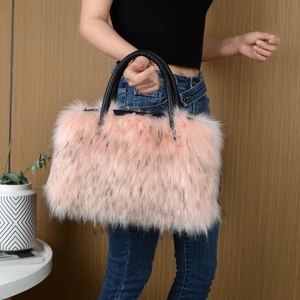 Detail of pink faux fur tote bag with black tips and leather handles on model