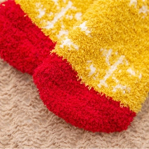 Thick coral fleece Christmas socks for women with red and yellow snowflake patterns
