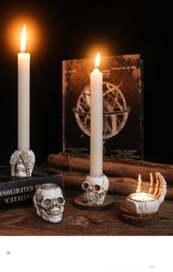 Close-up of vintage resin skull candle holder with glowing candle for Halloween decor