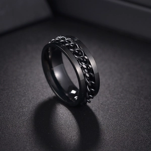 Detail of black stainless steel spinning ring with rotating chain for stress relief