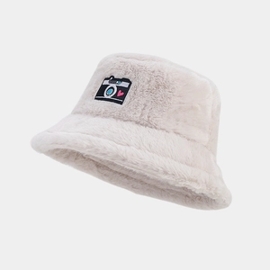Close-up of heart camera embroidery on plush faux fur bucket hat in warm beige