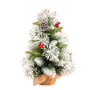 Mini tabletop Christmas tree with snow flocking, pine cones, red berries and burlap base