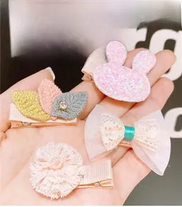 Detail of fully fabric-covered hair clips with sequined bunny and lace bow designs