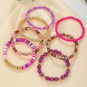 Detail of 7-piece acrylic crystal bead bracelet set with purple and gold resin accents