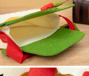 Close-up of felt Christmas gift bag showing red button detail and inner lining texture