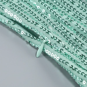 Macro shot of mint green sequins fabric and matching hidden zipper on the gown