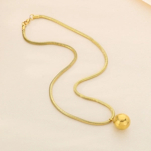 Detail of 18K gold plated stainless steel snake chain with hollow ball pendant charm