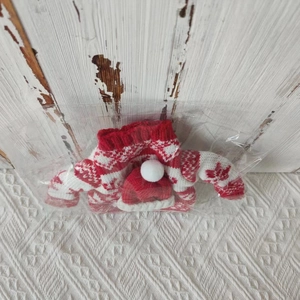 Close-up of knitted Christmas sweater wine bottle cover with reindeer pattern in packaging