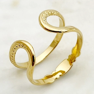 Close-up of golden wavy snake ring with blue natural stone on marble background