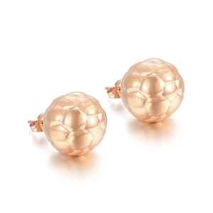 Macro shot of rose gold football-shaped stud earrings showing hexagonal texture details