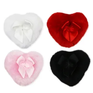 Set of four heart-shaped plush powder puffs in white, red, pink, and black with satin bows