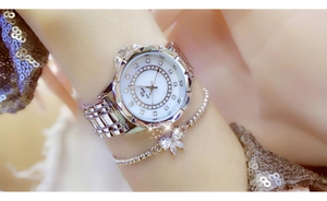 Close-up of BS Bee Sister silver rhinestone watch and beaded butterfly bracelet on wrist