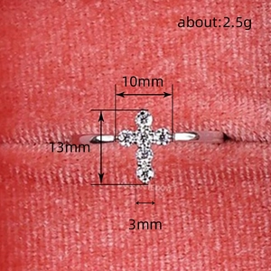 Elegant silver cross ring featuring six sparkling white cubic zirconia on red fabric base