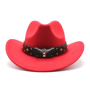 Close-up of red felt cowboy hat with silver bull head buckle and studded leather band