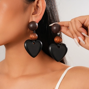Close-up of vintage heart drop earrings with acrylic beads on model's profile