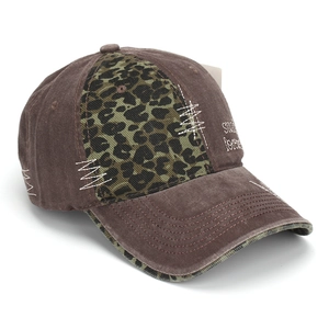 Macro detail of patchwork washed baseball cap with leopard print and Stay Forever embroidery