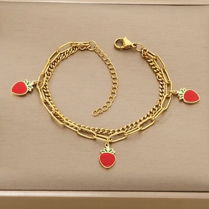 Detail of gold double-layered strawberry charms bracelet with lobster clasp and extension