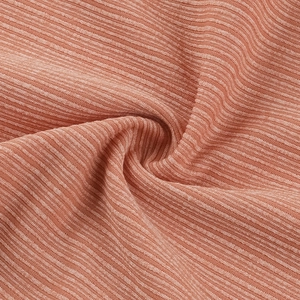 Macro della trama del tessuto a maglia a coste marrone arancio per elasticità e morbidezza
