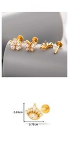 Detail view of gold-plated flat back lip studs with zircon butterfly and crown shapes