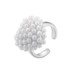 Macro shot of clusters of elegant white pearls on a silver vintage open ring design