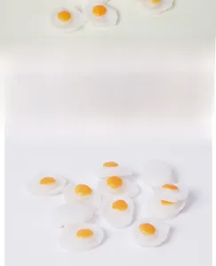 Detailed close-up of miniature PVC fried eggs for dollhouse DIY craft and play