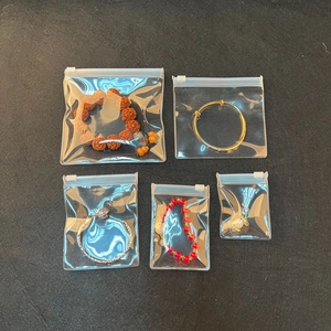 Macro shot of assorted jewelry pieces stored in moisture-proof EVA zip lock bags