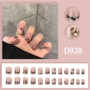 French zebra pattern press-on nails in nude pink with glitter and gold accents
