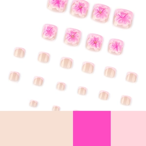 Pink 3D floral press-on toenails with French tips and golden bead accents on white background