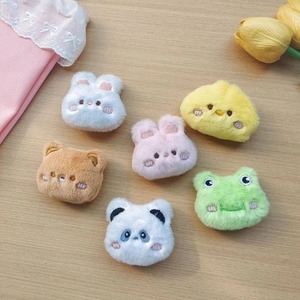 Set of cute plush animal heads including bear, bunny, frog, and panda on wood background